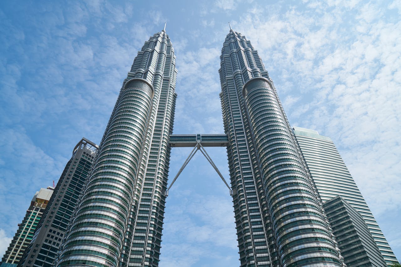 services-04 The iconic Petronas Twin Towers against a bright blue sky in Kuala Lumpur, Malaysia.